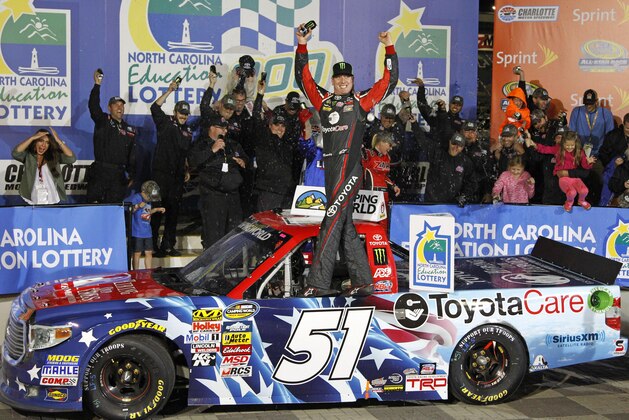 Kyle Busch celebrates in Victory Lane after winning the NASCAR Trucks series auto race at Charlotte Motor Speedway in Concord, N.C., Friday, May 16, 2014. (AP Photo/Terry Renna)