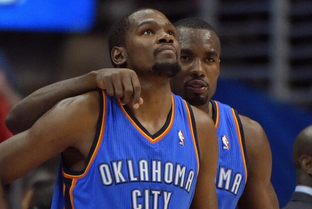 Oklahoma City Thunder forward Serge Ibaka, right, of Congo, puts his arm around forward Kevin Durant in the second half of Game 3 of the Western Conference semifinal NBA basketball playoff series against the Los Angeles Clippers, Friday, May 9, 2014, in Los Angeles. The Thunder won 118-112. (AP Photo/Mark J. Terrill)