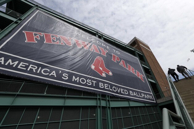 Fans enter Fenway Park before a baseball game between the Boston Red Sox and the Milwaukee Brewers in Boston, Friday, April 4, 2014. (AP Photo/Michael Dwyer)