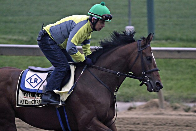 Preakness Stakes hopeful Kid Cruz, with exercise rider Reul Munoz aboard, gallops at Pimlico Race Course in Baltimore, Md., Wednesday, May 14, 2014. The 139th Preakness Stakes is Saturday, May 17.  (AP Photo/Garry Jones)
