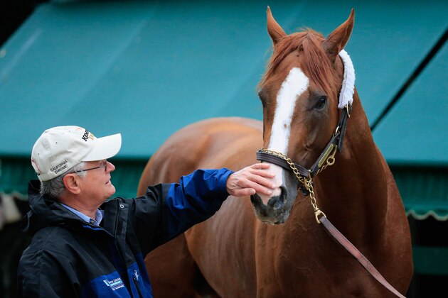 BALTIMORE, MD - MAY 14: Trainer Art Sherman pets his horse Kentucky Derby winner California Chrome following a morning workout in preparation for the 139th Preakness Stakes at Pimlico Race Course on May 14, 2014 in Baltimore, Maryland. (Photo by Rob Carr/Getty Images)