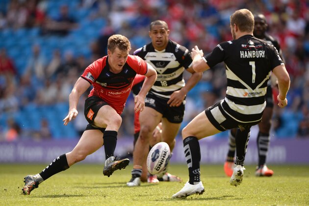 MANCHESTER, ENGLAND - MAY 17:  Jake Mullaney of Salford Red Devils kicks past Rhys Hanbury of Widnes Vikings during the Super League match between Widnes Vikings and Salford Red Devils at Etihad Stadium on May 17, 2014 in Manchester, England.  (Photo by Gareth Copley/Getty Images)
