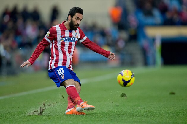 MADRID, SPAIN - DECEMBER 21: Arda Turan of Atletico de Madrid strikes the ball during the La Liga match between Club Atletico de Madrid and Levante UD at Vicente Calderon Stadium on December 21, 2013 in Madrid, Spain.  (Photo by Gonzalo Arroyo Moreno/Getty Images)