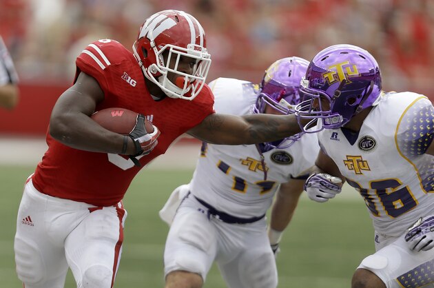 MADISON, WI - SEPTEMBER 07: Corey Clement #6 of the Wisconsin Badgers stiff arms Tevin McDermott #36 of the Tennessee Tech Golden Eagles while running upfield during the game at Camp Randall Stadium on September 07, 2013 in Madison, Wisconsin. (Photo by Mike McGinnis/Getty Images)