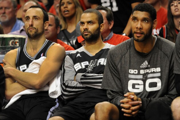 PORTLAND, OR - MAY 12: Manu Ginobili #20, Tony Parker #9 and Tim Duncan #21 of the San Antonio Spurs watch from the bench in the fourth quarter of Game Four of the Western Conference Semifinals during the 2014 NBA Playoffs at the Moda Center on May 12, 2014 in Portland, Oregon. The Blazers won the game 103-92. NOTE TO USER: User expressly acknowledges and agrees that, by downloading and or using this photograph, User is consenting to the terms and conditions of the Getty Images License Agreement. (Photo by Steve Dykes/Getty Images)