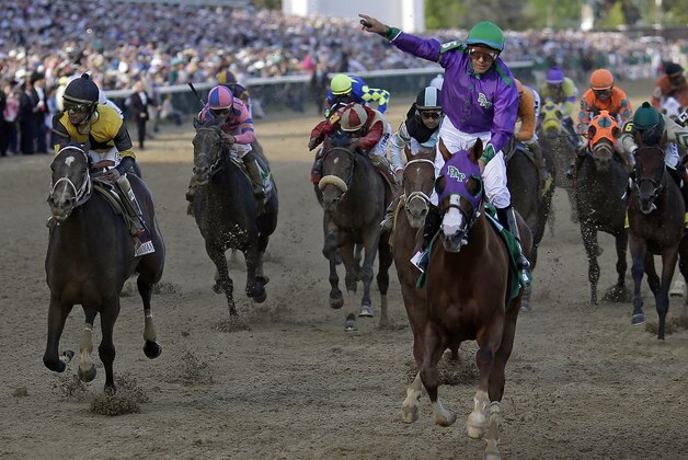 Victor Espinoza rides California Chrome to a victory during the 140th running of the Kentucky Derby horse race at Churchill Downs Saturday, May 3, 2014, in Louisville, Ky. (AP Photo/David J. Phillip)
