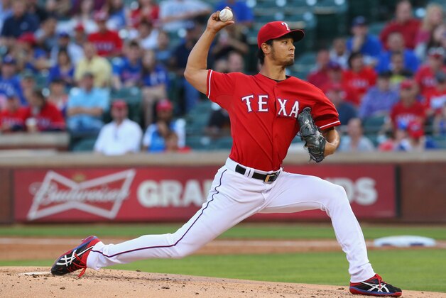ARLINGTON, TX - MAY 16:  Yu Darvish #11 of the Texas Rangers throws against the Toronto Blue Jays in the second inning at Globe Life Park in Arlington on May 16, 2014 in Arlington, Texas.  (Photo by Ronald Martinez/Getty Images)