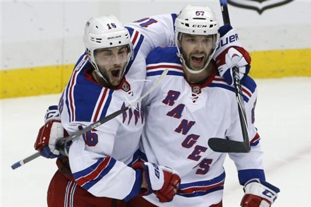 New York Rangers' Derick Brassard (16) celebrates his goal with Benoit Pouliot (67) in the first period of Game 5 of a second-round NHL playoff hockey series against the Pittsburgh Penguins in Pittsburgh, Friday, May 9, 2014. (AP Photo/Gene J. Puskar)