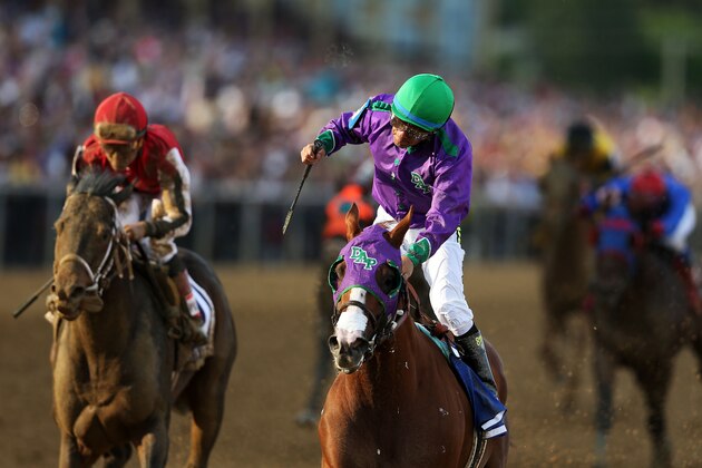 BALTIMORE, MD - MAY 17:  Victor Espinoza celebrates atop California Chrome #3 after winning the 139th running of the Preakness Stakes at Pimlico Race Course on May 17, 2014 in Baltimore, Maryland.  (Photo by Matthew Stockman/Getty Images)