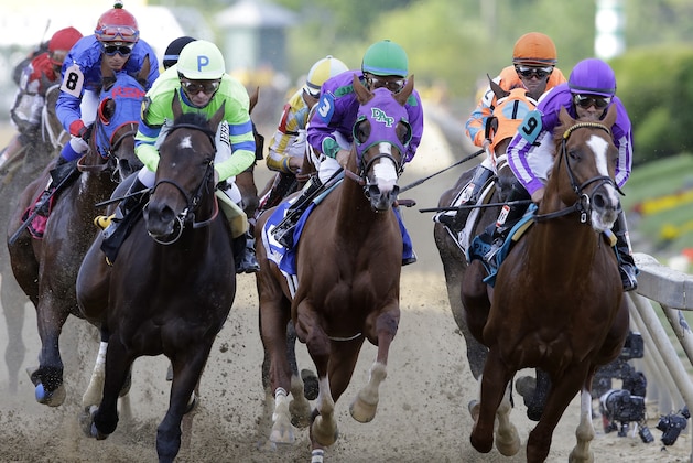 California Chrome, center, ridden by Victor Espinoza, Pablo Del Monte, right, ridden by Jeffrey Sanchez, and Ria Antonia, left, ridden by Calvin Borel, race to the first turn during the 139th Preakness Stakes horse race at Pimlico Race Course, Saturday, May 17, 2014, in Baltimore. California Chrome won the race. (AP Photo/Patrick Semansky)