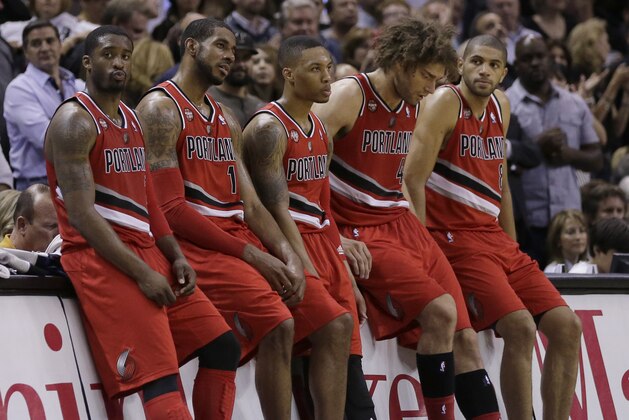 Portland Trail Blazers starters, from left, Wesley Matthews, LaMarcus Aldridge, Damian Lillard, Robin Lopez, and Nicolas Batum, sit on the scorers table during a timeout in the second half of Game 5 of a Western Conference semifinal NBA basketball playoff series against the San Antonio Spurs, Wednesday, May 14, 2014, in San Antonio. San Antonio won 104-82. (AP Photo/Eric Gay)