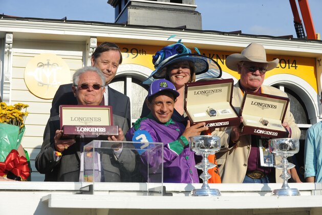 Charles Villoz, back row left, and Jennifer Judkins, back row center, both of Longines, present trainer Art Sherman, left, jockey Victor Espinoza and co-owner Steve Coburn with Longines Conquest Classic timepieces after their horse California Chrome won the 139th Preakness Stakes and the second leg of the Triple Crown, Saturday, May 17, 2014, in Baltimore, MD. Longines, the Swiss watchmaker known for its famous timepieces, is the Official Watch and Timekeeper of the 139th annual Preakness Stakes and the Triple Crown. (Diane Bondareff/Invision for Longines/AP Images)