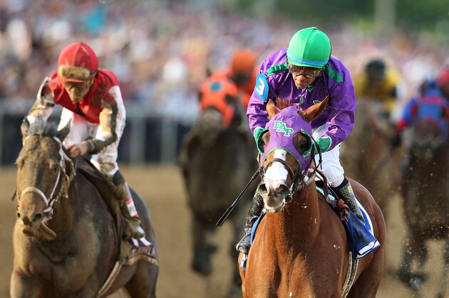 BALTIMORE, MD - MAY 17:  California Chrome #3, ridden by Victor Espinoza, races with the field during the 139th running of the Preakness Stakes at Pimlico Race Course on May 17, 2014 in Baltimore, Maryland.  (Photo by Matthew Stockman/Getty Images)