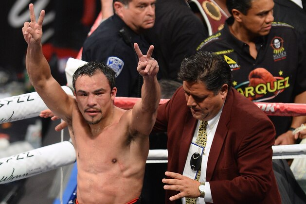 LAS VEGAS, NV - OCTOBER 12:  Juan Manuel Marquez raises his arms as he leaves the ring after his fight against WBO welterweight champion Timothy Bradley Jr. at the Thomas & Mack Center on October 12, 2013 in Las Vegas, Nevada. Bradley won in a split decision.  (Photo by Ethan Miller/Getty Images)