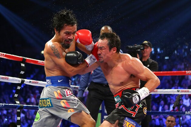 LAS VEGAS, NV - DECEMBER 08:  (L-R) Manny Pacquiao and Juan Manuel Marquez exchange blows during their welterweight bout at the MGM Grand Garden Arena on December 8, 2012 in Las Vegas, Nevada.  (Photo by Al Bello/Getty Images)