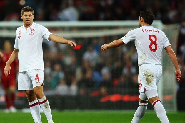 LONDON, ENGLAND - SEPTEMBER 11:  Steven Gerrard (L) of England passes the captains armband to Frank Lampard of England after being sent off by match referee Cuneyt Cakir during the FIFA 2014 World Cup Group H qualifying match between England and Ukraine at Wembley Stadium on September 11, 2012 in London, England.  (Photo by Laurence Griffiths/Getty Images)