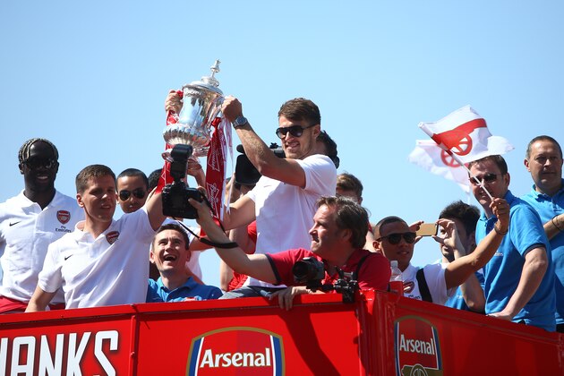 LONDON, ENGLAND - MAY 18: Wojciech Szczesny and Aaron Ramsey of Arsenal lift the FA cup during the Arsenal FA Cup Victory Parade on May 18, 2014 in London, England, (Photo by Charlie Crowhurst/Getty Images)