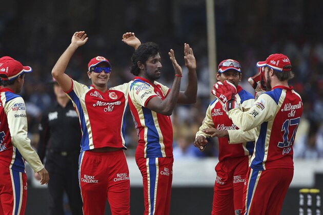Royal Challengers Bangalore bowler Prashanth Parmeshwaran, center, celebrates the wicket of Deccan Chargers batsman Cameron White  during their Indian Premier League (IPL) cricket match in Hyderabad, India, Sunday, May 20,2012. (AP Photo/Mahesh Kumar A.)