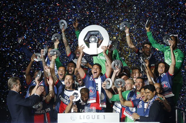 Paris Saint Germain's Brazilian defender Thiago Silva holds his trophy with teamates as he celebrates PSG's French League One title, at the Parc des Princes Stadium, in Paris, Saturday, May. 17, 2014.Paris Saint-Germain won the French League One Championship title on Saturday, the 4th in the club's history.(AP Photo/Jacques Brinon)