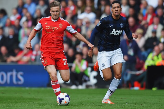 SOUTHAMPTON, ENGLAND - MAY 11:  (L-R) Luke Shaw of Southampton holds off Chris Smalling of Manchester United during the Barclays Premier League match between Southampton and Manchester United at St Mary's Stadium on May 11, 2014 in Southampton, England.  (Photo by Mike Hewitt/Getty Images)