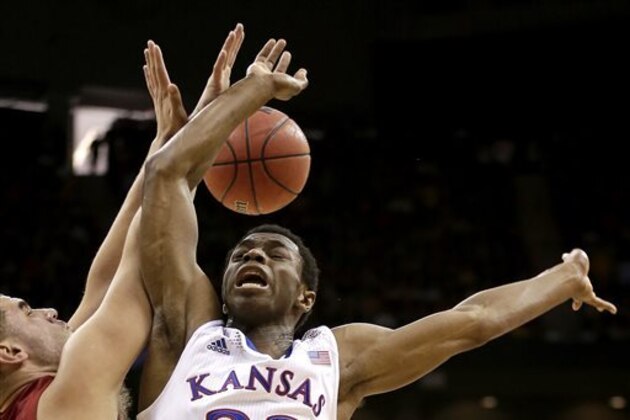 Iowa State's Monte Morris, left, and Kansas' Andrew Wiggins battle for a rebound during the first half of an NCAA college basketball game in the Big 12 men's tournament on Friday, March 14, 2014, in Kansas City, Mo. (AP Photo/Charlie Riedel)