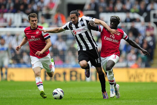 NEWCASTLE UPON TYNE, ENGLAND - MAY 19:  Jonas Gutierrez of Newcastle in action against Bacary Sagna (L) and Aaron Ramsey of Arsenal during the Barclays Premier League match between Newcastle United and Arsenal at St James' Park on May 19, 2013 in Newcastle upon Tyne, England. (Photo by Stu Forster/Getty Images)