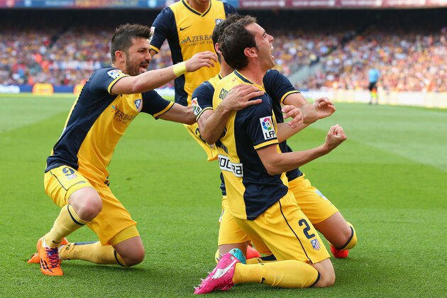BARCELONA, SPAIN - MAY 17:  Diego Godin of Club Atletico de Madrid celebrates after scoring his goal during the La Liga match between FC Barcelona and Club Atletico de Madrid at Camp Nou on May 17, 2014 in Barcelona, Spain.  (Photo by Alex Livesey/Getty Images)