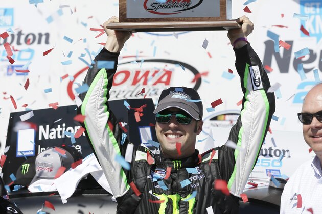 Sam Hornish Jr. holds the trophy after winning the NASCAR Nationwide auto race, Sunday, May 18, 2014, at Iowa Speedway in Newton, Iowa. (AP Photo/Charlie Neibergall)