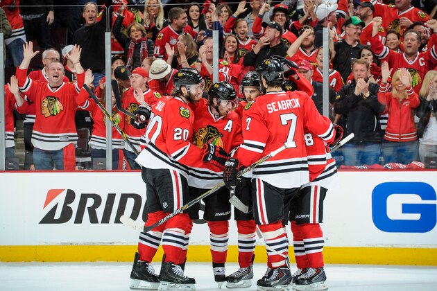 CHICAGO, IL - MAY 18: Duncan Keith #2 of the Chicago Blackhawks (middle) celebrates with teammates, including Brandon Saad #20 and Marcus Kruger #16, after scoring against the Los Angeles Kings in the second period in Game One of the Western Conference Final during the 2014 NHL Stanley Cup Playoffs at the United Center on May 18, 2014 in Chicago, Illinois. (Photo by Bill Smith/NHLI via Getty Images)
