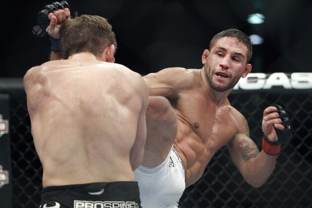 Chad Mendes, right, battles Nik Lentz in a UFC Mixed Martial Arts featherweight bout in Sacramento, Calif., on Saturday, Dec. 14, 2013.(AP Photo/Steve Yeater)
