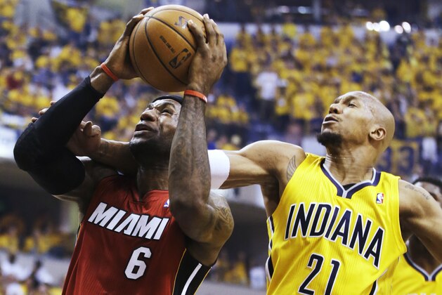Indiana Pacers forward David West (21) tries to stop a shot by Miami Heat forward LeBron James (6) during the first half of Game 1 of the Eastern Conference finals NBA basketball playoff series Sunday, May 18, 2014, in Indianapolis.  (AP Photo/Darron Cummings)