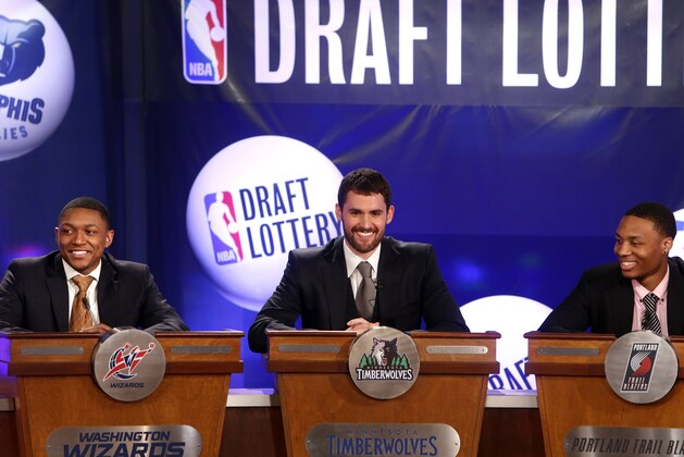 NBA basketball players, from left, Washington Wizards' Bradley Beal, Minnesota Timberwolves' Kevin Love and Portland Trailblazers' Damian Lillard represent their teams during the NBA draft lottery, Tuesday, May 21, 2013 in New York. (AP Photo/Jason DeCrow)
