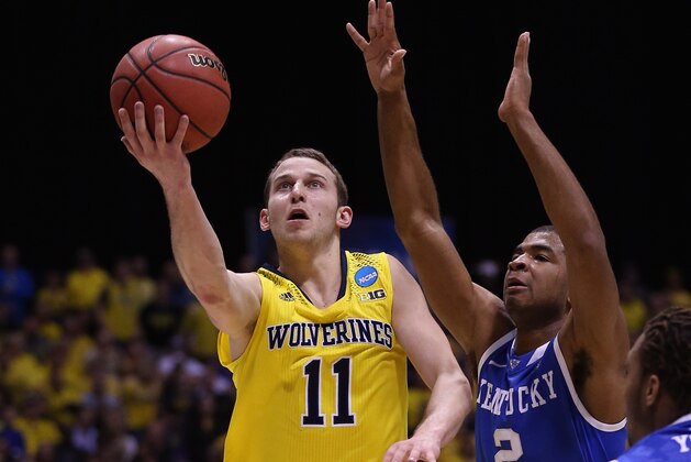 INDIANAPOLIS, IN - MARCH 30: Nik Stauskas #11 of the Michigan Wolverines shoots the ball against Aaron Harrison #2 of the Kentucky Wildcats during the midwest regional final of the 2014 NCAA Men's Basketball Tournament at Lucas Oil Stadium on March 30, 2014 in Indianapolis, Indiana. (Photo by Jonathan Daniel/Getty Images) INDIANAPOLIS, IN - MARCH 30: Nik Stauskas #11 of the Michigan Wolverines shoots the ball against Aaron Harrison #2 of the Kentucky Wildcats during the midwest regional final of the 2014 NCAA Men's Basketball Tournament at Lucas Oil Stadium on March 30, 2014 in Indianapolis, Indiana. (Photo by Jonathan Daniel/Getty Images)