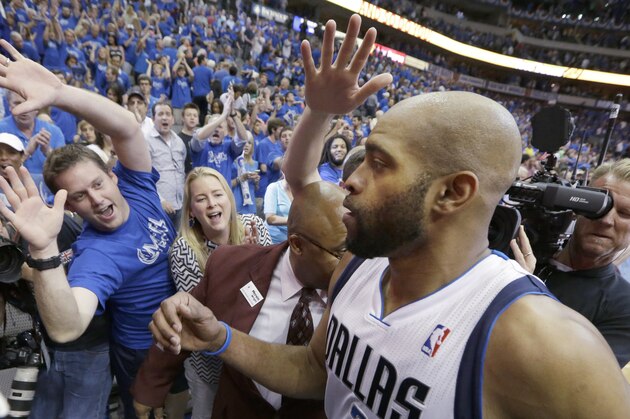 Dallas Mavericks guard Vince Carter comes off the court as fans reach out to him  after Game 3 of an NBA basketball first-round playoff series against the San Antonio Spurs in Dallas, Saturday, April 26, 2014. (AP Photo/LM Otero)