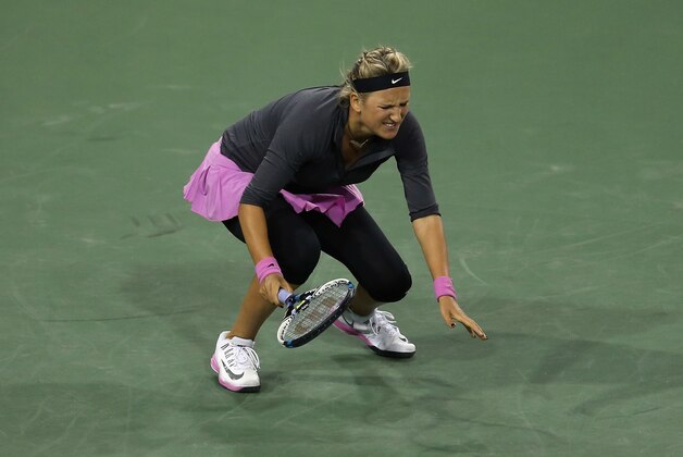 INDIAN WELLS, CA - MARCH 07:  Victoria Azarenka of Belarus winces in pain after returning a shot to Lauren Davis during the BNP Paribas Open at Indian Wells Tennis Garden on March 7, 2014 in Indian Wells, California.  (Photo by Jeff Gross/Getty Images)