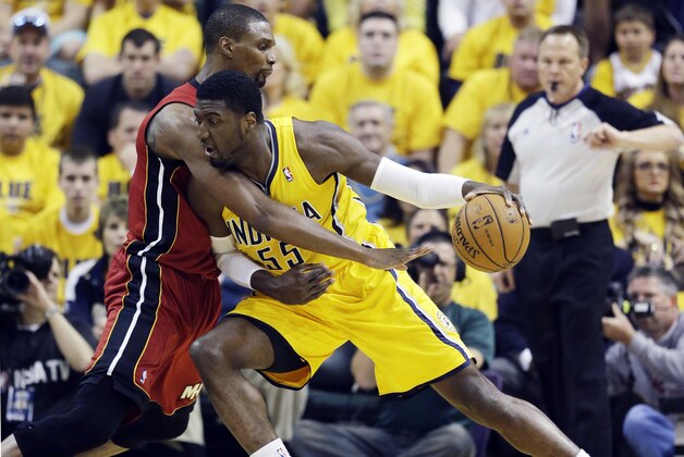 Indiana Pacers center Roy Hibbert (55) drives against Miami Heat center Chris Bosh during the first half of Game 1 of the Eastern Conference finals NBA basketball playoff series, Sunday, May 18, 2014, in Indianapolis. (AP Photo/Darron Cummings)