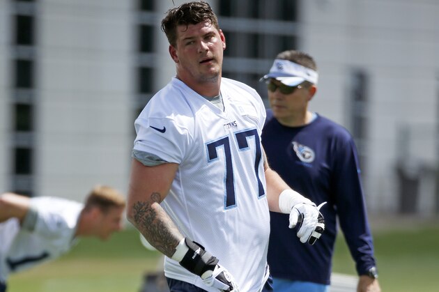 Tennessee Titans tackle Taylor Lewan (77) stretches during NFL football rookie minicamp Friday, May 16, 2014, in Nashville, Tenn. (AP Photo/Mark Humphrey)