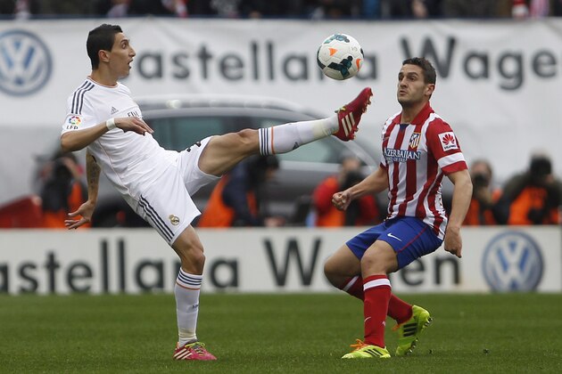 Real's Angel Di Maria, left, in action with Atletico's Koke, right, during a Spanish La Liga soccer match between Atletico de Madrid and Real Madrid at the Vicente Calderon stadium in Madrid, Spain, Sunday, March 2, 2014. (AP Photo/Gabriel Pecot)