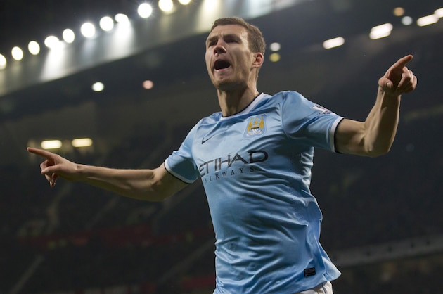 Manchester City's Edin Dzeko celebrates after scoring his second goal against Manchester United during their English Premier League soccer match at Old Trafford Stadium, Manchester, England, Tuesday March 25, 2014. (AP Photo/Jon Super)