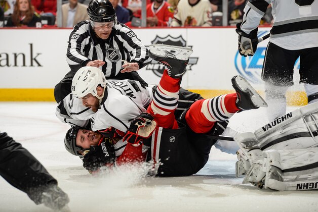 CHICAGO, IL - MAY 18: Linesman Scott Driscoll #68 attempts to break up Willie Mitchell #33 of the Los Angeles Kings and Bryan Bickell #29 of the Chicago Blackhawks in Game One of the Western Conference Final during the 2014 NHL Stanley Cup Playoffs at the United Center on May 18, 2014 in Chicago, Illinois. (Photo by Bill Smith/NHLI via Getty Images)
