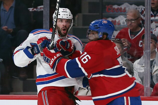 MONTREAL, QC - MAY 17:  Benoit Pouliot #67 of the New York Rangers is hit by P.K. Subban #76 of the Montreal Canadiens in Game One of the Eastern Conference Final during the 2014 Stanley Cup Playoffs at the Bell Centre on May 17, 2014 in Montreal, Canada. The Rangers defeated the Canadiens 7-2.  (Photo by Bruce Bennett/Getty Images)