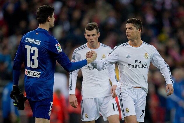 MADRID, SPAIN - MARCH 02: Cristiano Ronaldo (L) of Real Madrid CF wrinkles his eye and shakes hands with  goalkeeper Thibaut Courtois (L) of Atletico de Madrid after the La Liga match between Club Atletico de Madrid and Real Madrid CF at Vicente Calderon Stadium on March 2, 2014 in Madrid, Spain.  (Photo by Gonzalo Arroyo Moreno/Getty Images)