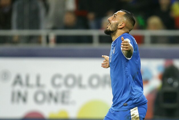 Greece's Kostas Mitroglou celebrates after scoring a goal during the World Cup qualifying playoff second leg soccer match against Romania at the National Arena in Bucharest, Tuesday, Nov. 19, 2013. (AP Photo/Vadim Ghirda)