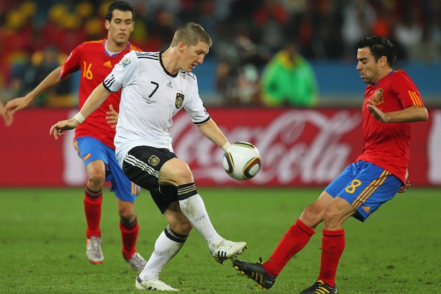 DURBAN, SOUTH AFRICA - JULY 07: Bastian Schweinsteiger of Germany and Xavi Hernandez of Spain battle for the ball during the 2010 FIFA World Cup South Africa Semi Final match between Germany and Spain at Durban Stadium on July 7, 2010 in Durban, South Africa.  (Photo by Cameron Spencer/Getty Images)