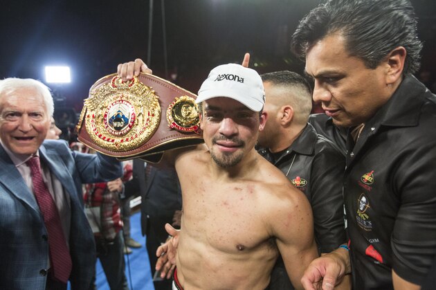 Juan Manuel Márquez, of Mexico, celebrates with championship belt after his victory over Mike Alvarado in the tenth round of a WBO welterweight title boxing match at the Forum in Inglewood, Calif., Saturday, May 17, 2014.  (AP Photo/Ringo H.W. Chiu)