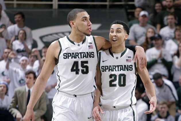 Michigan State's Denzel Valentine (45) and Travis Trice (20) talk during the second half of an NCAA college basketball game against Iowa, Thursday, March 6, 2014, in East Lansing, Mich. Michigan State won 86-76. (AP Photo/Al Goldis)