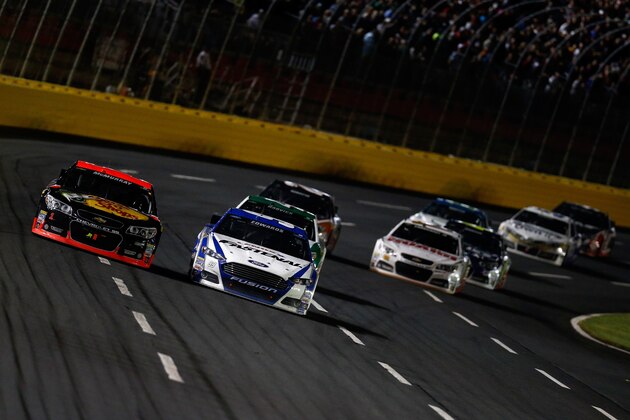CHARLOTTE, NC - MAY 17: Jamie McMurray, driver of the #1 Bass Pro Chevrolet, races Carl Edwards, driver of the #99 Fastenal Ford, during the NASCAR Sprint Cup Series Sprint All-Star Race at Charlotte Motor Speedway on May 17, 2014 in Charlotte, North Carolina.  (Photo by Jeff Zelevansky/Getty Images)