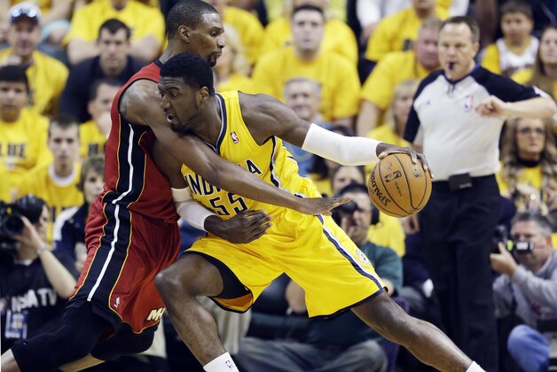Indiana Pacers center Roy Hibbert (55) drives against Miami Heat center Chris Bosh during the first half of Game 1 of the Eastern Conference finals NBA basketball playoff series, Sunday, May 18, 2014, in Indianapolis. (AP Photo/Darron Cummings)