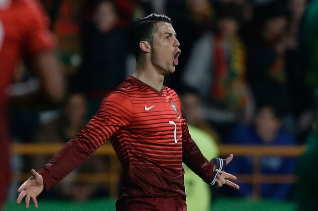 Portugal's Cristiano Ronaldo celebrates after scoring the opening goal during their friendly soccer match with Cameroon Wednesday, March 5 2014, in Leiria, Portugal. The game is part of both teams' preparation for the World Cup in Brazil. (AP Photo/Armando Franca)