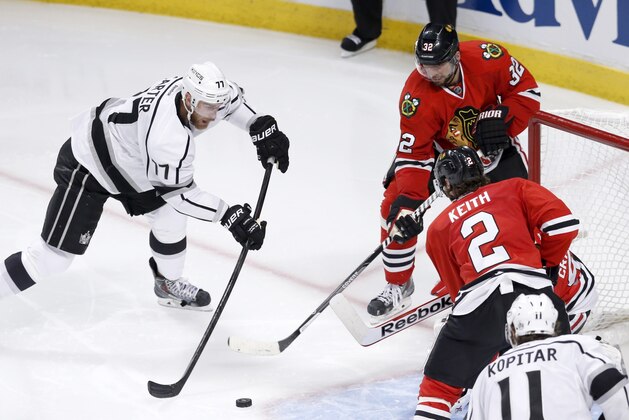 Los Angeles Kings center Jeff Carter shoots, but is unable to score past a defensive wall of Chicago Blackhawks' Michal Rozsival (32)  Corey Crawford and Duncan Keith, during the third period of Game 1 of the Western Conference finals in the NHL hockey Stanley Cup playoffs in Chicago. The Blackhawks' defense is playing a key role in this postseason run as the Kings found out how hard it is to score on the defending Stanley Cup champions. (AP Photo/Charles Rex Arbogast)